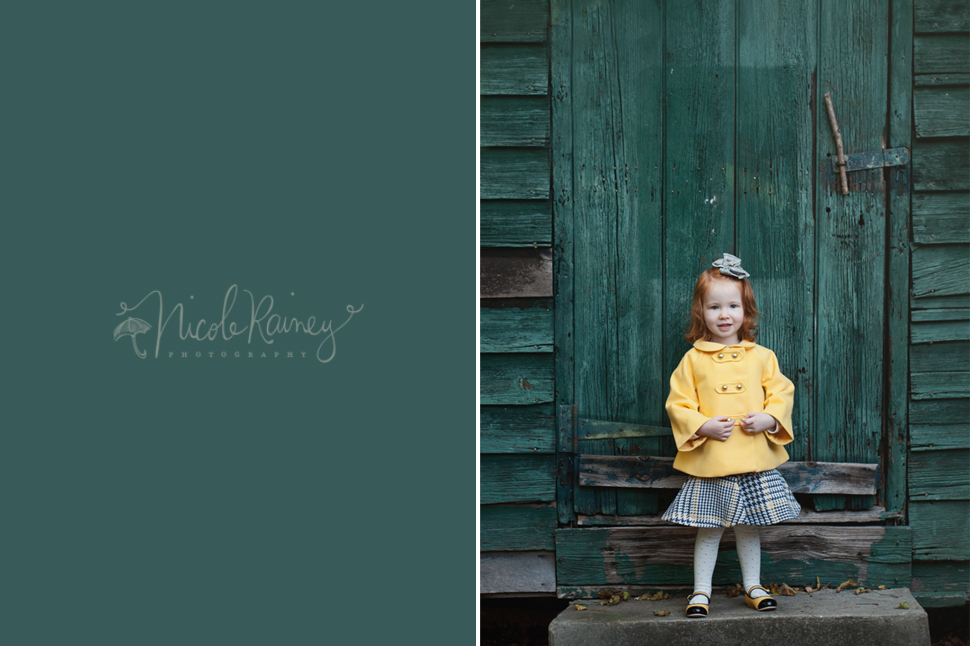 Red headed little girl in yellow jacket in front of teal wall